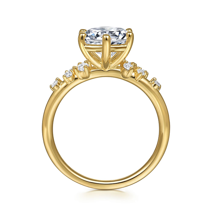 The image displays a side view of the Gabriel & Co 14K Y floral band engagement ring, featuring a large round center diamond in a four-prong setting and smaller diamonds along the band, shown against a white background.