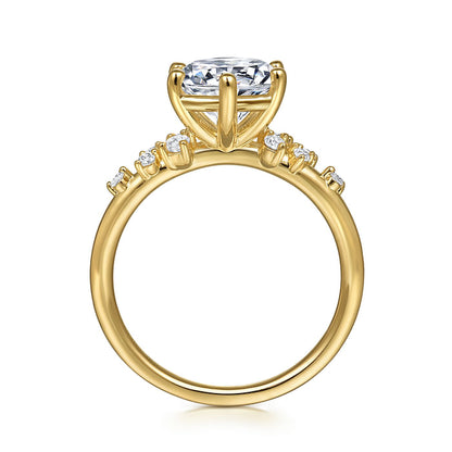 The image displays a side view of the Gabriel & Co 14K Y floral band engagement ring, featuring a large round center diamond in a four-prong setting and smaller diamonds along the band, shown against a white background.
