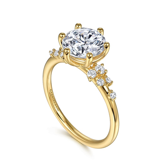 The 14K Y floral band engagement ring by Gabriel & Co features a large prong-set CZ center, smaller diamond accents, and an elegant signature engraving on the side for a timeless look.