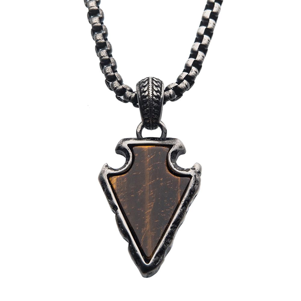 An INOX necklace featuring a Men's Tiger Eye Stone with Gun Metal Plated Frame Pendant on a Black P. The arrowhead-shaped pendant showcases a polished brown tiger eye stone, intricately edged with decorative silver for a rugged, antiqued appearance.