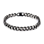 The Black IP Diamond Cut Chain Bracelet by INOX features a sleek, interlocking Cuban link design with alternating black and silver links made of durable stainless steel and includes a secure clasp.