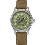 The Khaki Field Titanium Automatic 42mm by Hamilton features a wristwatch with a brown leather strap and a silver casing. Its olive green dial includes white numerical hour markings, an inner 24-hour track, and displays the "Hamilton" brand name alongside "Khaki Field Titanium Automatic." Additionally, the date window is positioned at 3 o'clock, highlighting its military watch heritage.