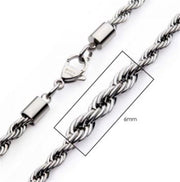 A close-up image of the INOX 6mm Steel Rope Chain Necklace, showcasing a lobster clasp. A rectangular overlay highlights a 6mm section of the chain, indicating its thickness. The intricate twisted design of the links is prominently displayed. This piece measures 20 inches in length.