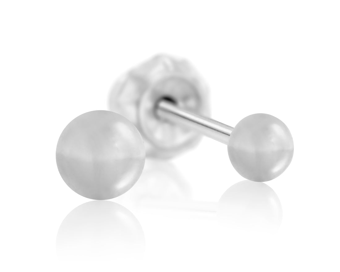 A close-up image of a single Inverness Titanium Piercing Stud Earring with a round, smooth, pearl-like end and a flat Inverness Safety Back™. The hypoallergenic earring is sealed in sterile packaging and is shown resting on a highly reflective white surface, casting a faint reflection below.