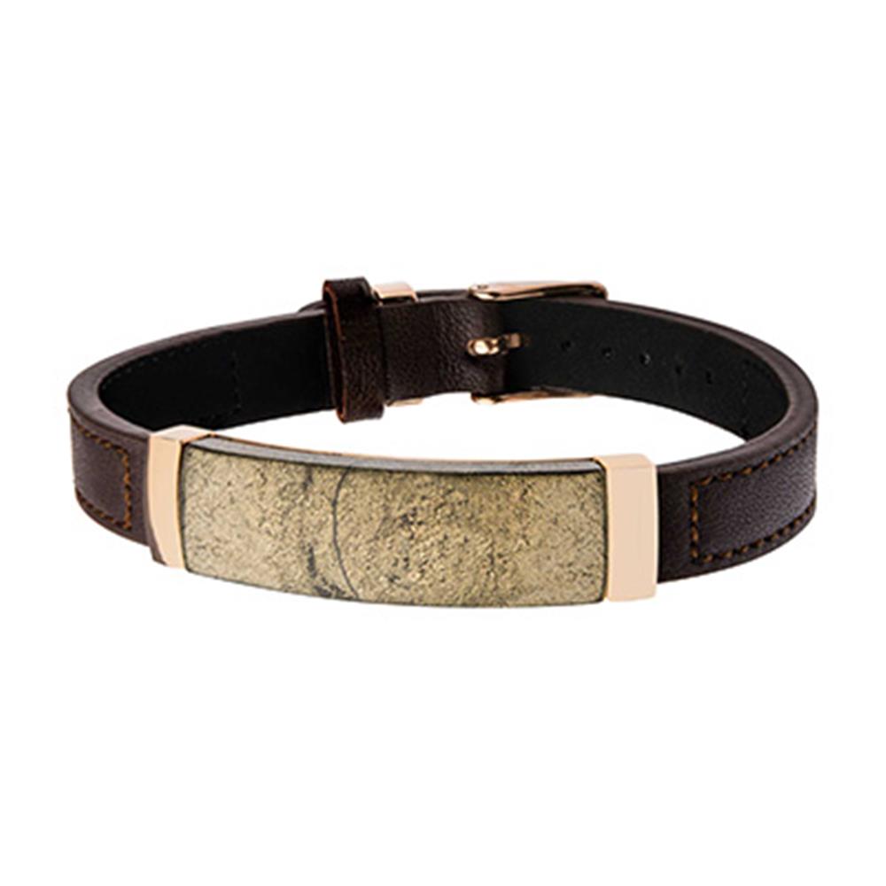 A close-up image of the stylish Men's Chalcopyrite Brown Leather Bracelet by INOX, showcasing a wide, rectangular metallic plate with a weathered, antique finish. The bracelet features a belt-like buckle clasp for adjustable sizing.
