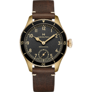 Introducing the Hamilton Khaki Aviation Pioneer Steel 43mm (M5G21FGL0), a refined gold-colored mechanical wristwatch. It boasts a dark brown leather strap and features a black dial adorned with gold-tone Arabic numerals and hands. A subdial at the 6 o'clock position tracks seconds, while the bezel is detailed with minute and second indicators for precision timekeeping.