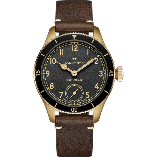 Introducing the Hamilton Khaki Aviation Pioneer Steel 43mm (M5G21FGL0), a refined gold-colored mechanical wristwatch. It boasts a dark brown leather strap and features a black dial adorned with gold-tone Arabic numerals and hands. A subdial at the 6 o'clock position tracks seconds, while the bezel is detailed with minute and second indicators for precision timekeeping.