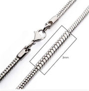 A close-up image of a silver, 3mm Steel Rattail Chain | 20" | INOX men's necklace with a lobster clasp. The chain's diameter is shown to be 3mm, with an inset zoom displaying the detailed texture of the interlocking links.