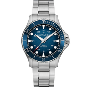 The Hamilton Khaki Navy Scuba Automatic Watch showcases a 43mm case paired with a stainless steel bracelet. This men's wristwatch features a round blue dial with silver hour markers, luminescent hands, and a date function positioned at 4 o'clock. The blue bezel sports silver indices and the watch is water-resistant up to 300 meters.