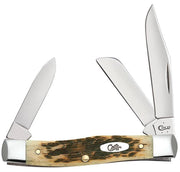 The Amber Bone Peach Seed Jig Med. Stockman by W.R. Case & Sons Cutlery Co. features three stainless steel blades of varying sizes and shapes. Its rustic Amber Bone handle, adorned with a Peach Seed Jig pattern and metallic ends, is held together by two visible brass pins, creating a timeless appearance. The brand "Case" is inscribed on both the handle and one of the blades.
