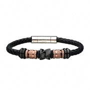 The Men's Stainless Steel Black Bracelet by INOX is meticulously crafted from black braided leather and features eye-catching rose gold plated and black cylindrical beads. It includes a sleek silver-tone barrel clasp, with the central beads adorned in intricate patterns for a stylish and sophisticated touch.
