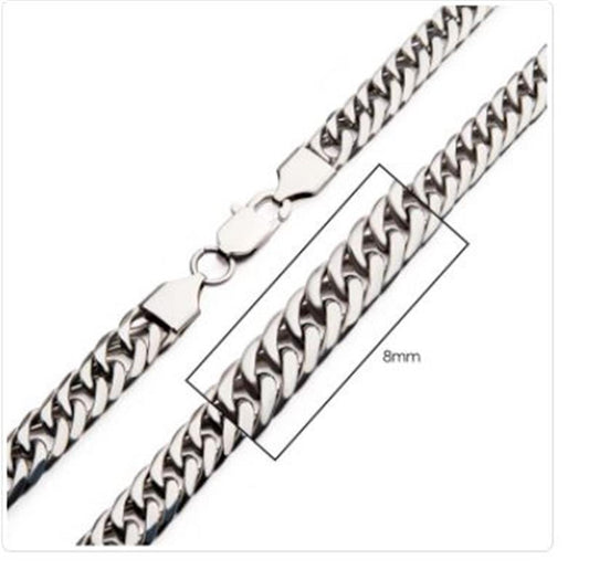 A close-up image of the 8mm Steel Dome Curb Chain bracelet by INOX, showcasing its silver links and lobster clasp. A highlighted box indicates the width of the links as "8mm." This elegant piece can seamlessly complement any stainless steel necklace, adding a refined touch to your ensemble.