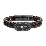 The INOX Men's Black & Brown Braided Leather Bracelet features intertwined strands of black and brown leather. Central to its design is a gun metal plated longhorn on a rectangular metal plate, complemented by a sleek magnetic clasp for easy wear.