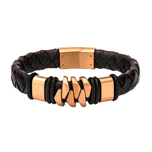 The INOX Men's Rose Gold IP with Brown Leather Bohemian Bracelet features a stylish design, with a brown braided leather band and gold-tone metal accents, highlighted by an interlocking chain design at the center and secured with a magnetic clasp.