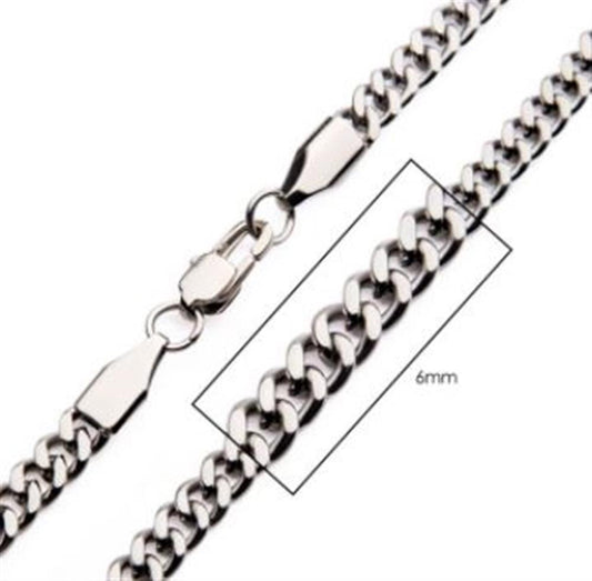Close-up image of the shiny silver 6mm Steel Diamond Cut Curb Chain from INOX, designed for men and featuring a lobster clasp. A box around a section of the chain highlights its width, emphasizing the thickness of its links.