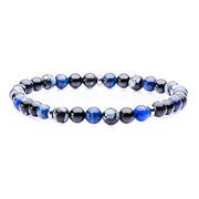 Introducing the Men's Stainless Steel and Sodalite, Black Agate, Snowflake Beads Brace by INOX: a sophisticated round beaded men’s bracelet featuring polished blue sodalite beads and glossy black agate stones. The stretchable band ensures a comfortable fit, and the uniformly spherical stones add to its elegance. Displayed against a white background, this bracelet is both stylish and versatile.