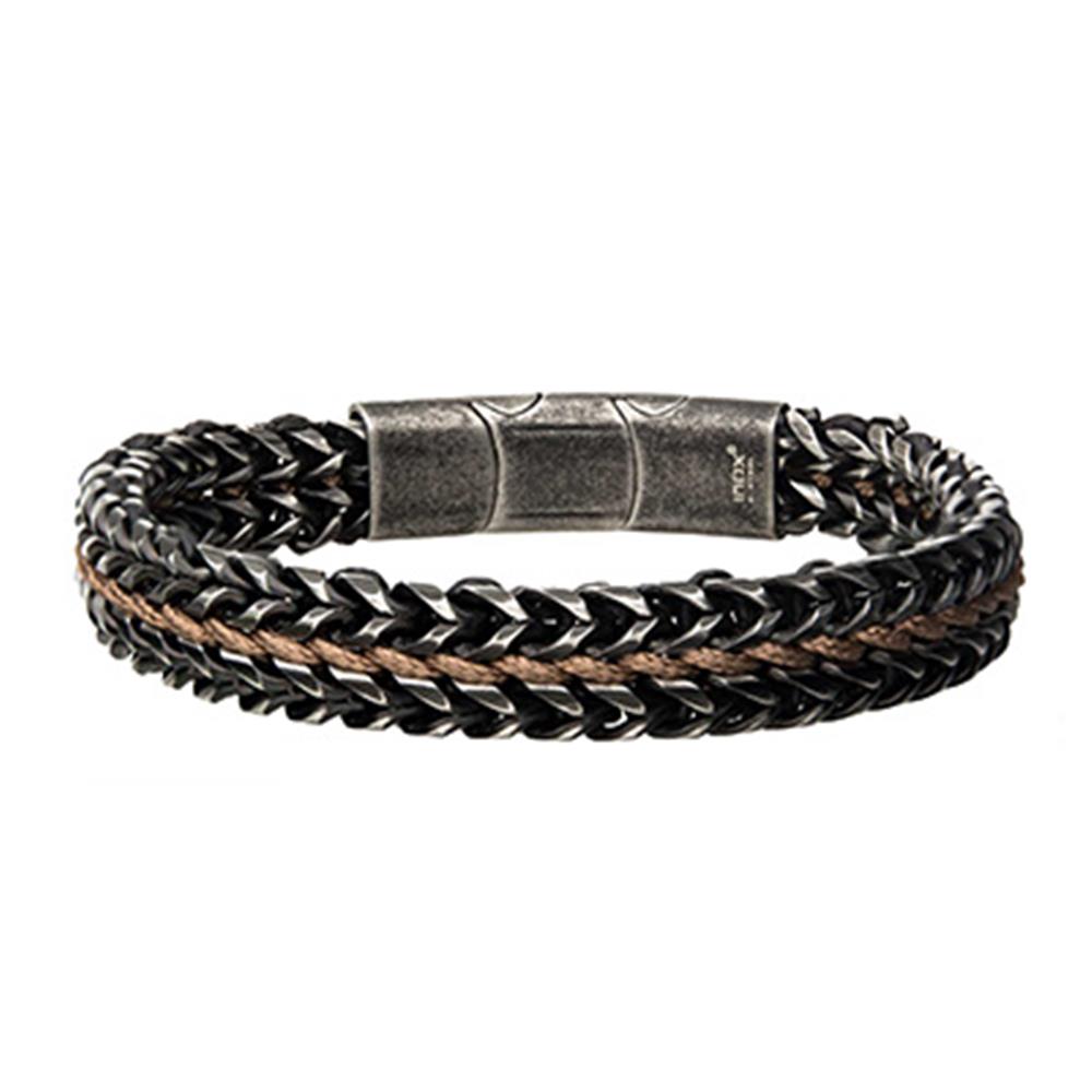 The Allegiance Stainless Steel Bracelet from INOX features interwoven black and brown leather strands, complemented by a textured, magnetic slide clasp in the center that gives it a sleek and modern look.