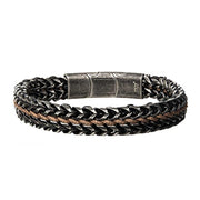 The Allegiance Stainless Steel Bracelet from INOX features interwoven black and brown leather strands, complemented by a textured, magnetic slide clasp in the center that gives it a sleek and modern look.