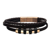 The INOX Men's Stainless Steel with Black and Rose Gold Beads Brown Multi Leath bracelet showcases stylish braided and smooth black leather bands, adorned with gold-toned metal and black circular beads. This elegant accessory is secured with a rectangular gold-toned clasp.