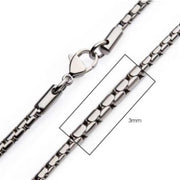 A close-up image of the 3mm Steel Boston Link Chain by INOX, measuring 24 inches. The stainless steel chain features interlocking rectangular links and is secured with a lobster clasp. A section is highlighted in a rectangle to emphasize its width.