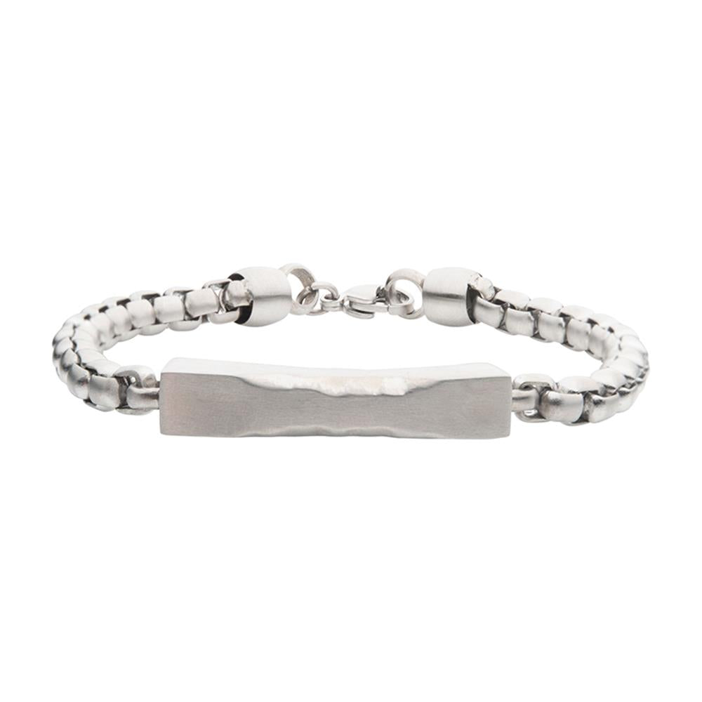 The Matte Steel Chiseled Engravable Drop with Bold Box Chain Bracelet by INOX features a sleek men's box chain design with a chiseled, engravable rectangular plate in the center. The bracelet showcases rounded, smooth chain links and a matte surface with a secure clasp closure.