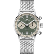 The Hamilton Intra-Matic Automatic Chronograph features a 40mm silver case with a mesh band, showcasing a green and cream panda dial adorned with three small sub-dials and a date display at the 6 o'clock position. The brand "Hamilton" is prominently displayed on the dial, while two pushers and a crown on the right side enhance its vintage appeal.