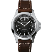The Hamilton Khaki Field King Automatic Watch, with a 40mm stainless steel case, features a sophisticated brown leather band and a black dial adorned with white hour markers and hands. The watch also includes a date window at the 12 o'clock position displaying Saturday the 8th, highlighting its classic military time design.