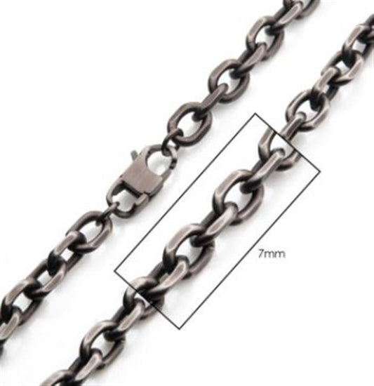 Close-up of a metallic 7mm Oxidized Steel Knife Edge Link Chain | 24" | INOX with oval links, a lobster clasp, and a labeled box highlighting a section of the chain. The text within the box reads "7mm," indicating the size of the chain links. This 24 inch necklace is displayed against a white background.