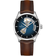 Product Description: The Jazzmaster Open Heart Automatic Watch by Hamilton features a brown leather strap paired with a silver case. Its smoked blue dial showcases an open-heart design, exposing the intricate automatic movement within. The dial is emblazoned with the brand name "Hamilton" and includes silver hour markers and hands, indicative of its place in the prestigious Jazzmaster Open Heart collection.