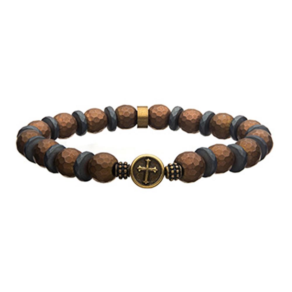 The Men's 10mm Hematite Stone Bracelet by INOX features alternating brown and gray faceted beads on a coppertone silicone string, with a circular gold-colored centerpiece showcasing a cross design and highlighted with hematite stone accents.
