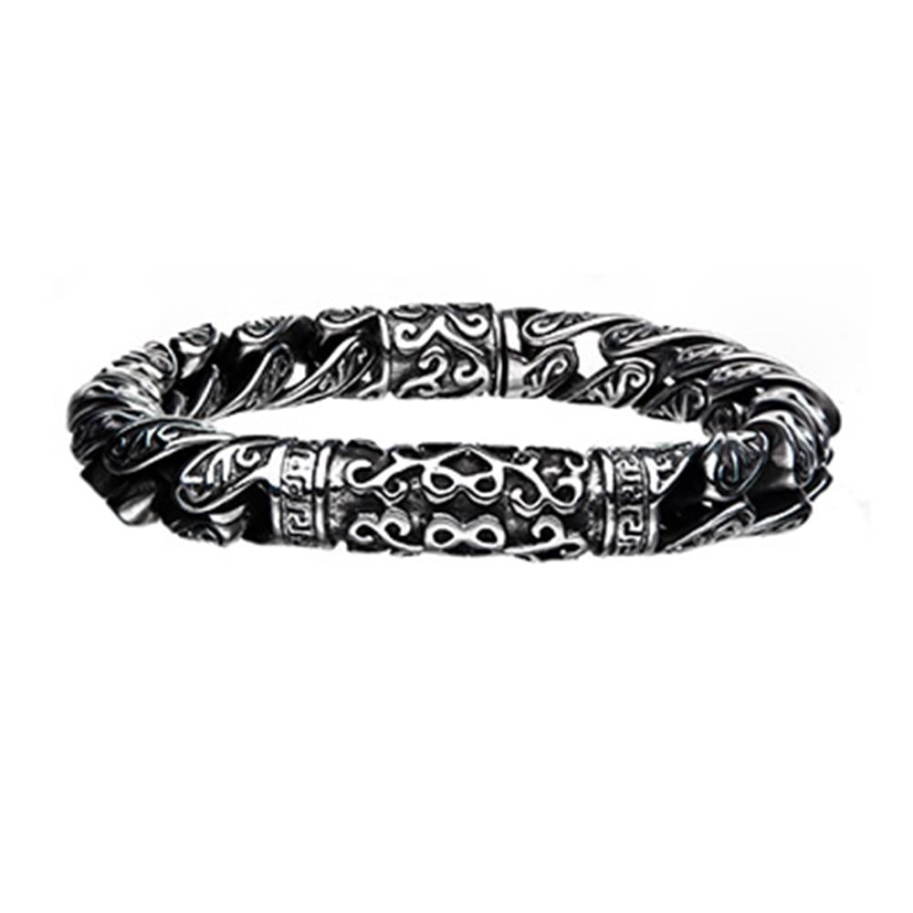 The Men's Stainless Steel Oxidized Bracelet by INOX features intricate, decorative patterns and a slightly twisted design. This elegant bracelet boasts detailed engravings that form a symmetrical motif, giving it a vintage and stylish appearance.