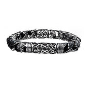 The Men's Stainless Steel Oxidized Bracelet by INOX features intricate, decorative patterns and a slightly twisted design. This elegant bracelet boasts detailed engravings that form a symmetrical motif, giving it a vintage and stylish appearance.