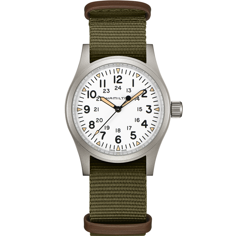 The Khaki Field Mechanical Watch with NATO Strap by Hamilton features a white dial with black numerals displaying both 12-hour and 24-hour time formats. It has a silver case, an olive green nylon strap, and showcases the brand name "Hamilton" on the dial, highlighting its military heritage. The watch hands are black with luminous tips.