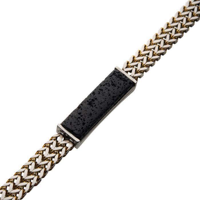 The INOX Stainless Steel Gold Plated Double Franco Chain with Lava Stone ID Link Bracelet features a stylish two-tone woven chain in silver hues and a rectangular black textured lava stone set in a sleek silver frame at the center.