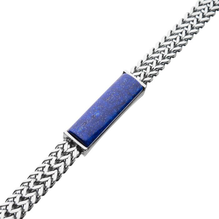 The INOX Stainless Steel Double Franco Chain with Lapis Stone ID Link Bracelet is a stylish men's accessory that features a double Franco chain and a rectangular lapis stone ID in the center. The blue lapis stone has a slight shimmer, adding a touch of elegance to the bracelet.