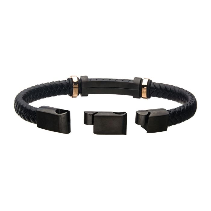Introducing the Men's Stainless Steel 8mm Black and Rose Gold Plated with Black Braided Leather ID Bracelet by INOX. This sophisticated piece features a black braided leather design accented with a rectangular center piece, two metallic loops flanked by rose gold-colored rings, and a dark magnetic clasp mechanism for secure fastening—combining elegance with functionality at its finest.
