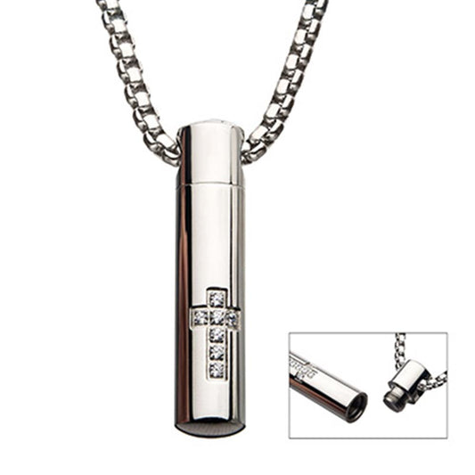 The INOX Stainless Steel Memorial Cross Pendant with Clear CZ features a silver cylindrical design hanging from a 22-inch steel box chain, adorned with a cross design made from clear CZ gemstones. An inset image reveals the pendant unscrewed to show a hidden compartment inside.