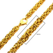 A close-up image of the 6mm 18K Gold Plated King Byzantine Chain necklace by INOX, featuring intricate links. One section is highlighted with a rectangle, showing a width measurement of 6mm. This men's stainless steel necklace comes equipped with a lobster clasp for fastening.