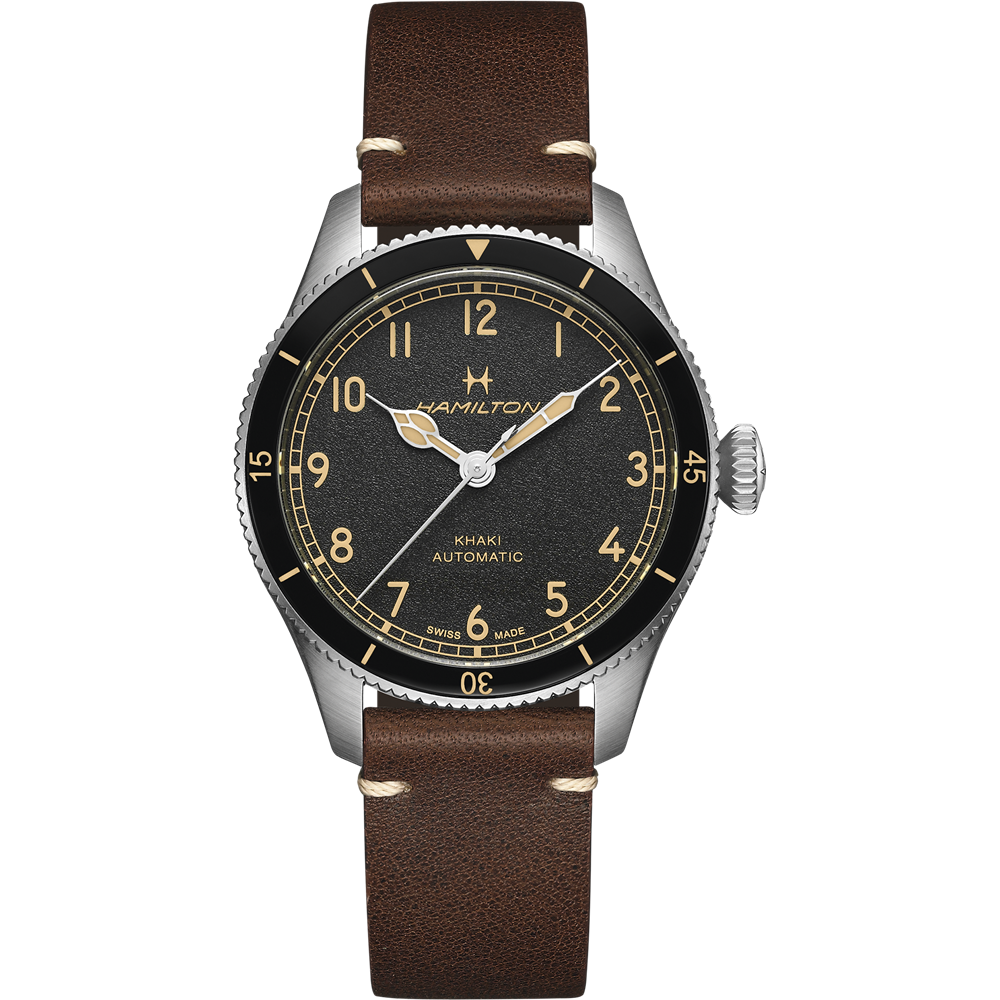 The Hamilton Aviation Pilot Pioneer Automatic Watch (38mm) features a brown leather strap and a silver case. Its black dial showcases gold numerals, hands, and smaller military time indicators. The silver bezel is adorned with minute markers, contributing to the watch's classic, vintage appearance that pays homage to Hamilton's aviation heritage.