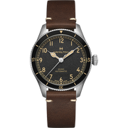 The Hamilton Aviation Pilot Pioneer Automatic Watch (38mm) features a brown leather strap and a silver case. Its black dial showcases gold numerals, hands, and smaller military time indicators. The silver bezel is adorned with minute markers, contributing to the watch's classic, vintage appearance that pays homage to Hamilton's aviation heritage.