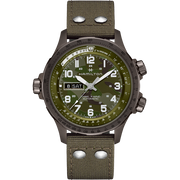 The Hamilton Khaki Aviation X-Wind Automatic Watch features a round face with three hands, displaying both date and day information. It has large white numerals on a camouflage-patterned dial and is equipped with a durable olive-green fabric strap that includes two metal rivets near the lugs. Additionally, there are three function buttons located on the side.