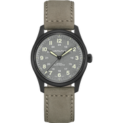 A Hamilton Khaki Field Titanium Automatic 38mm watch, featuring a matte black titanium case and gray dial, paired with a beige leather strap. The dial is accented with luminous hands and numerals, includes a 24-hour inner ring, and has a date display at the 3 o'clock position. The strap features white stitching along the edges—an embodiment of classic military watch design.