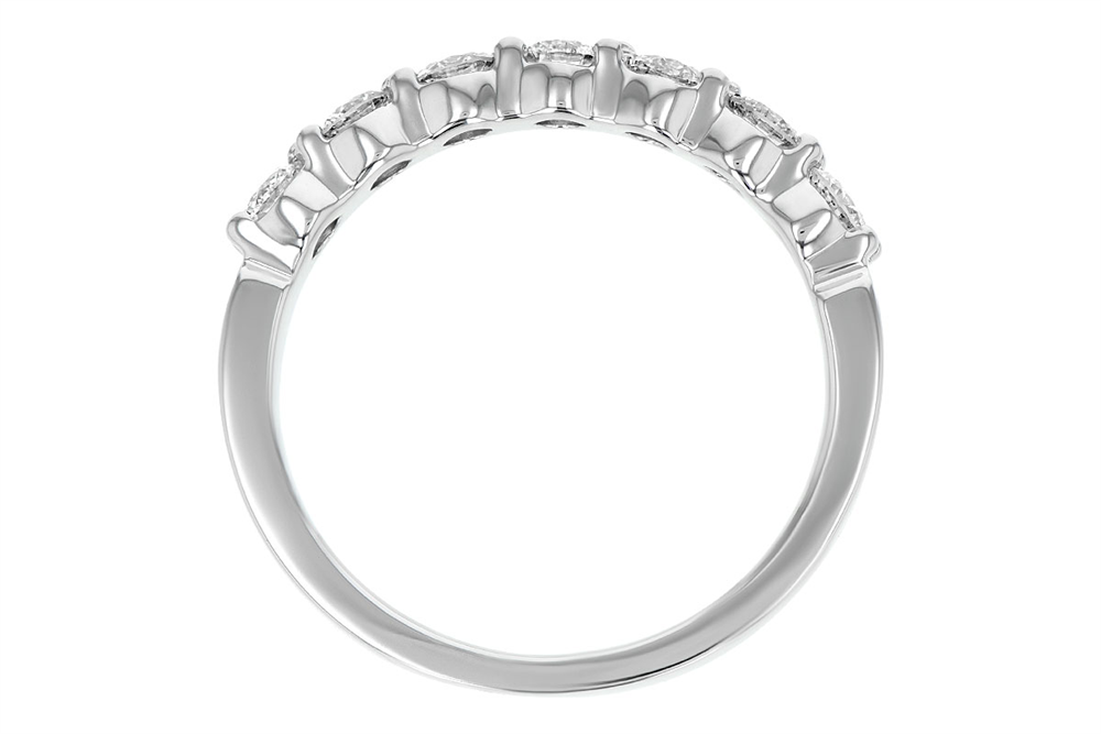 A close-up view of the Ladies Wedding Band 14k White Gold Ring by Allison Kaufman reveals a prong-set silver band adorned with a row of small shimmering diamonds along the top half. The smooth, reflective surface of this 14k white gold ring showcases the brilliance of the stones. Captured from a side angle, it highlights the ring's elegantly curved design.