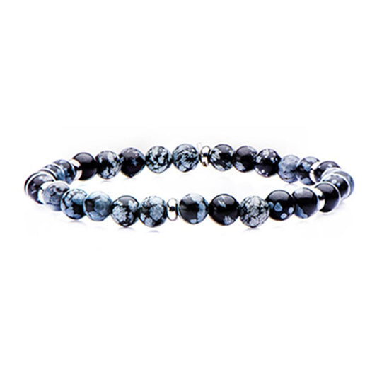 The INOX Stainless Steel Snowflake Beaded Stretch Bracelet, featuring black and gray speckled round beads arranged in a circular pattern, offers a simple yet elegant jewelry piece. Measuring 8 inches in length, this bracelet adds a touch of sophistication to any outfit.