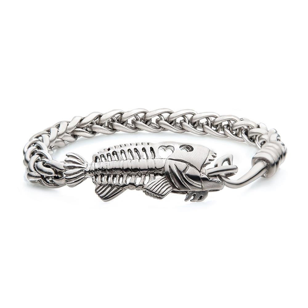 The Polished Steel Wheat Chain with Fishbone on Hook Clasp Bracelet by INOX features a detailed fish hook and fish skeleton centerpiece, complete with textured bones and a braided wheat chain link design. The stainless steel bracelet boasts a reflective metallic finish.