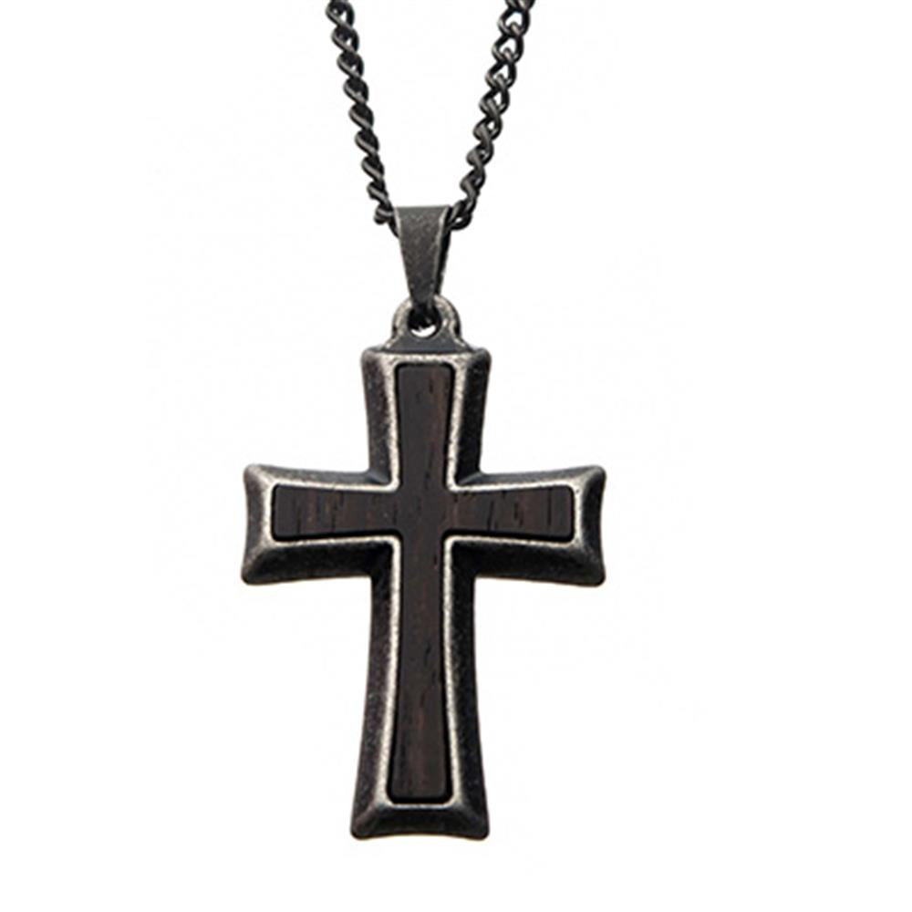 The Men's Stainless Steel with Antiqued Finish Cross Pendant from INOX hangs from a sturdy curb chain. The cross, featuring a dark inlay at the center, boasts an antiqued finish that contrasts elegantly with the polished metal edges. The background is plain white.