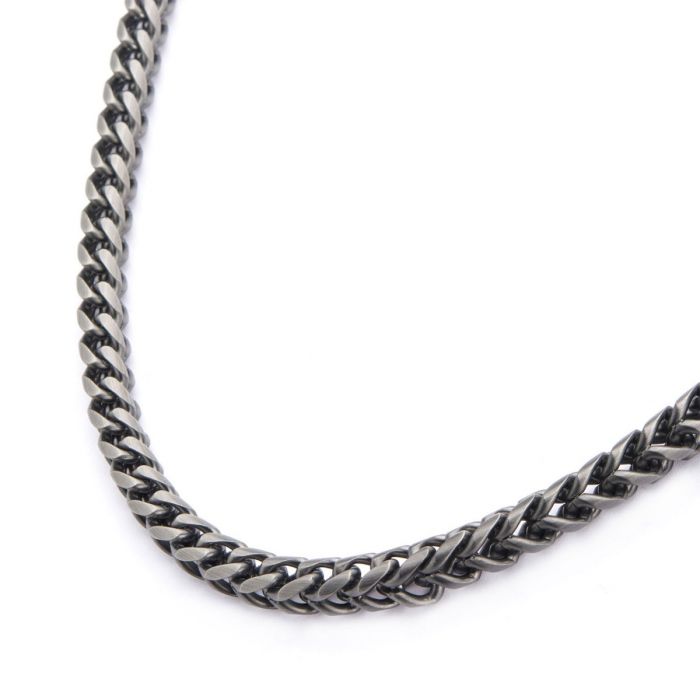 A close-up view of the Hollis Bahringer Men's Stainless Steel Necklace by INOX, featuring a sleek fox tail link design. The silver-toned chain is arranged in a slight curve, showcasing its interlocking pattern against a plain white background.