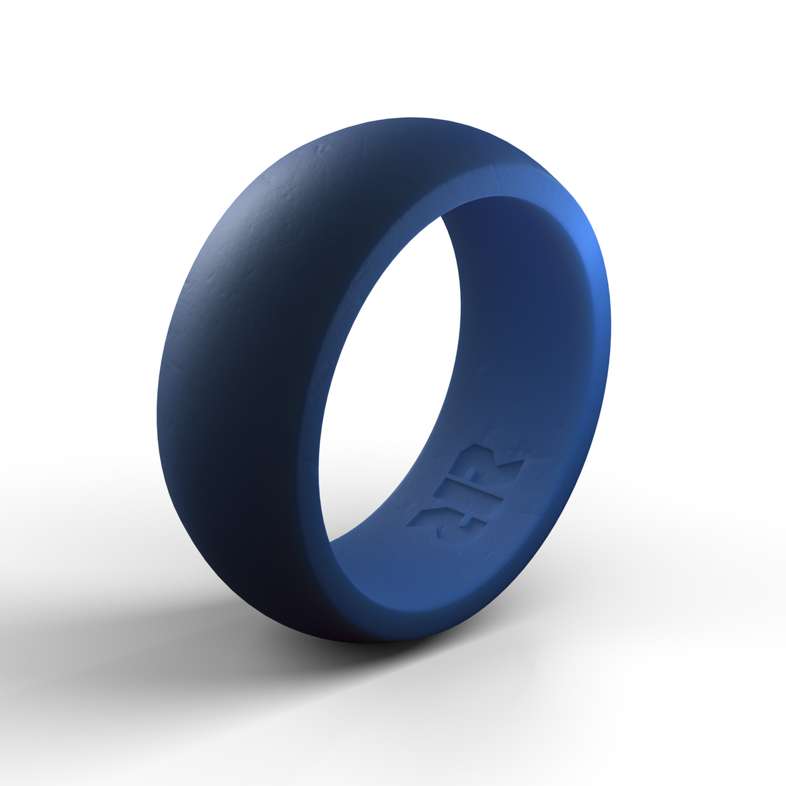 A Men's Navy Blue Silicone Wedding Ring by Baxley Jewelry with a smooth texture and a logo engraved on the inner band is shown against a plain white background. The men's silicone wedding ring is standing upright, casting a soft shadow.