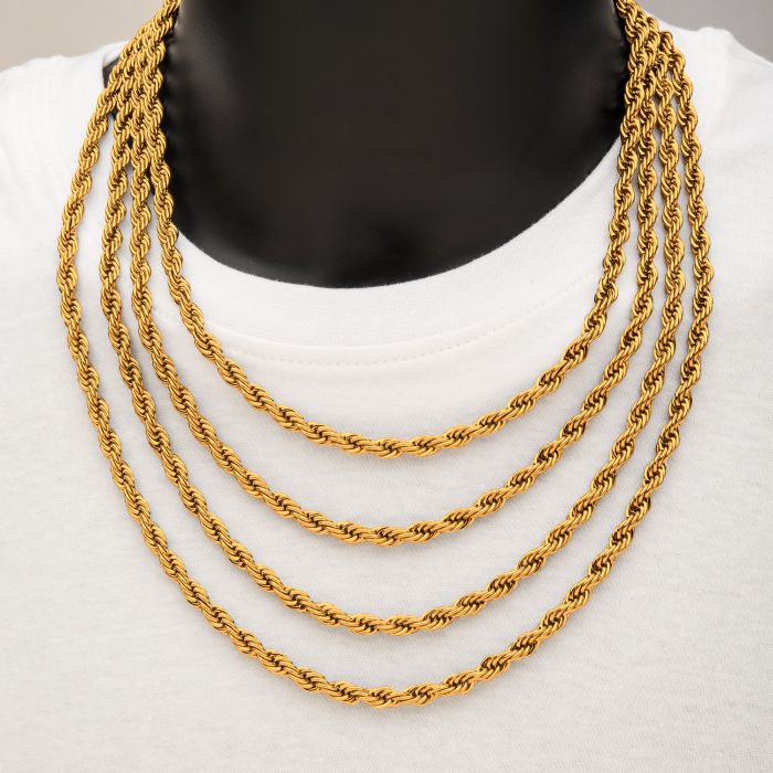 A person wearing a white shirt is adorned with four layers of the INOX 6mm 18K Gold Plated Rope Chains, each meticulously designed in a consistent and intricate rope style. The black background enhances the visual contrast, highlighting the men's necklaces made from durable stainless steel.
