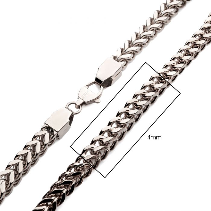 A close-up image of the 4mm Steel Franco Chain necklace from INOX, featuring a lobster clasp. The chain's width is showcased with a labeled box indicating 4mm, and it boasts a thick, intricate, and shiny link design.